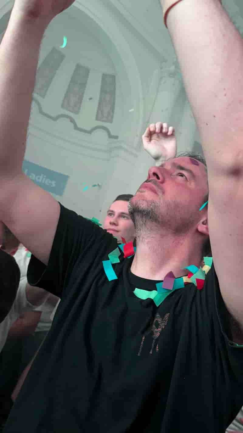 My friend Bramus dancing to Born Slippy NUXX, his arms are raised in the air as though he is worshipping Underworld (he probably was) and he is covered in confetti